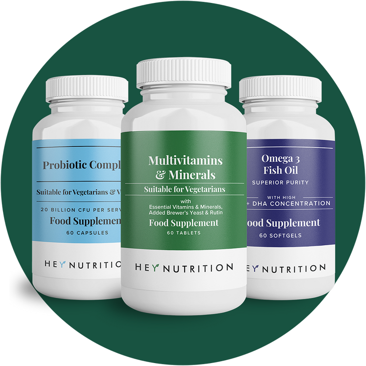 Three Hey Nutrition supplement bottles: Probiotic Complex, Multivitamins & Minerals, and Omega 3 Fish Oil, arranged on a dark green background