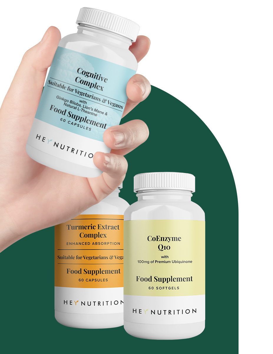 A hand holding the Cognitive Complex supplement bottle from Hey Nutrition, with Turmeric Extract Complex and CoEnzyme Q10 bottles displayed in the background.