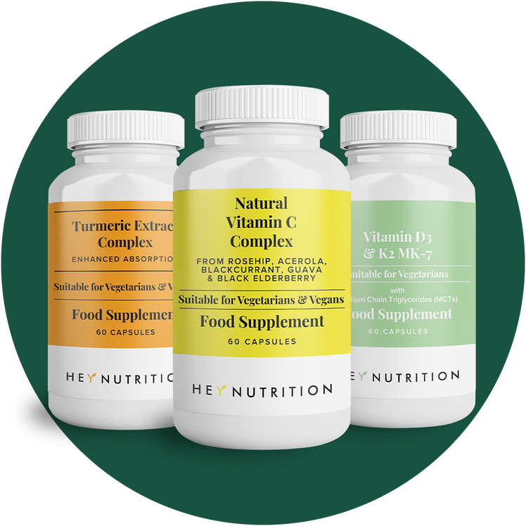 Three Hey Nutrition supplement bottles—Turmeric Extract Complex, Natural Vitamin C Complex, and Vitamin D3 & K2 MK-7—shown against a dark green background.